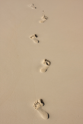 bare feet footprints in the sand on beach
